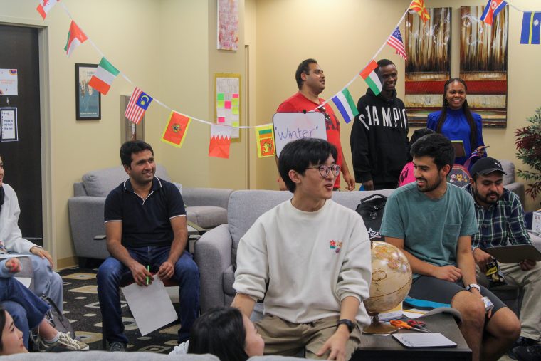 Students smiling and talking in the Multicultural Center.