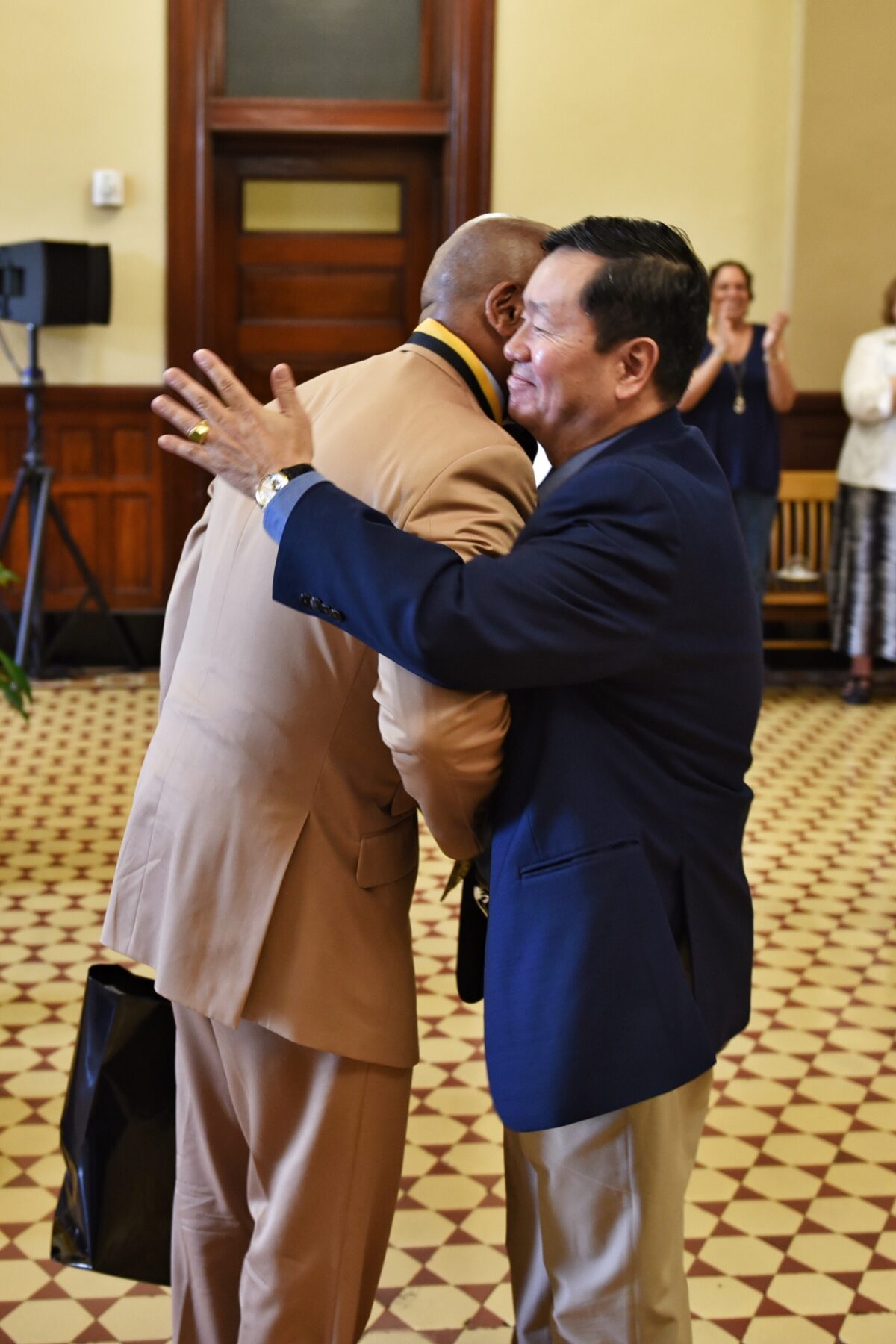 Kevin McDonald hugs UM System President Mun Choi.