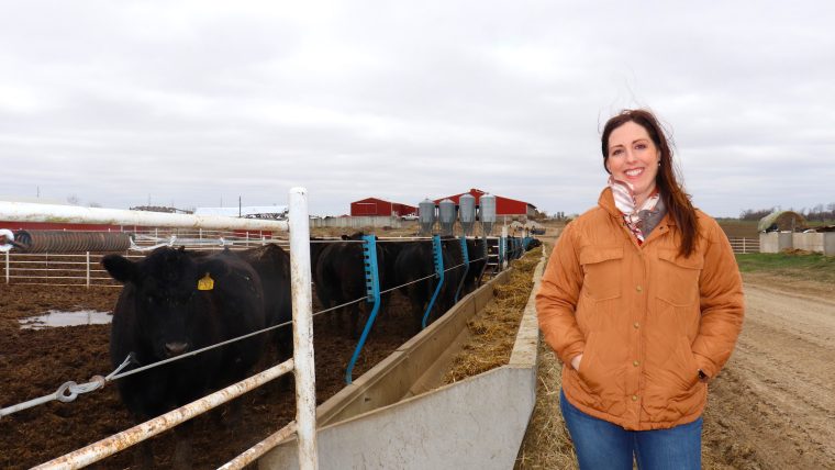 Marion County farmer Amy Meyer Lehenbauer poses for photo near livestock on farm.
