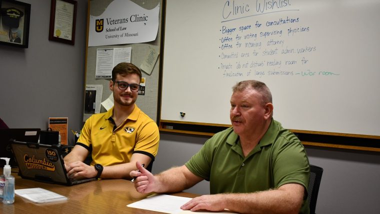 Staff member Eugene O'Loughlin and teaching assistant Alex Hockman take a meeting in the School of Law Veterans Clinic.
