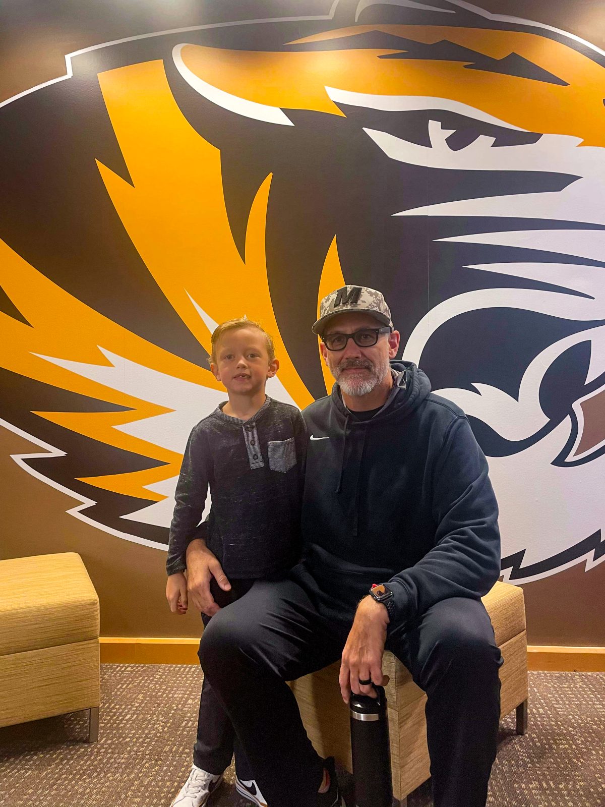 Stirling Patrick and Rob Patrick at fall 2023 STEM Cubs with Mizzou Tiger on the wall behind them. 