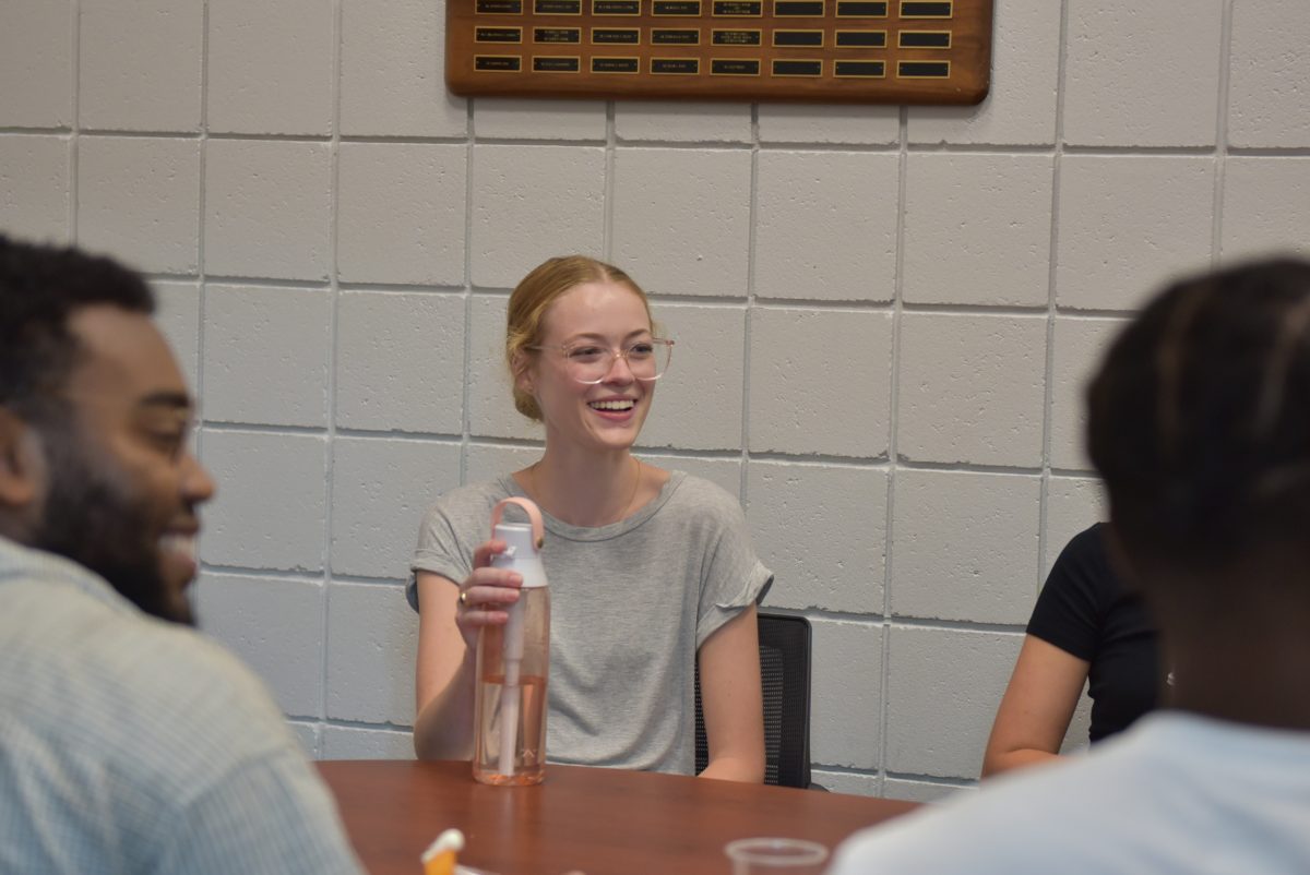 Mary Kilcullen smiling and talking with students at the Gaines/Oldham Black Culture Center’s Rise & Grind breakfast. 