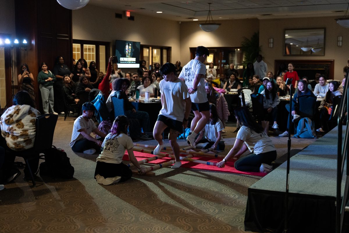 The Filipino Student Association presents the traditional Tinikling dance, characterized by rhythmic clapping of bamboo sticks on the floor as a dancer gracefully navigates between them. 